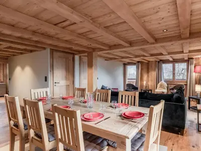 a dining room with a wooden table and chairs at Chalet rénové pour 10 pers., St-Gervais, balcon, parking - FR-1-663-54 in Saint-Gervais-les-Bains