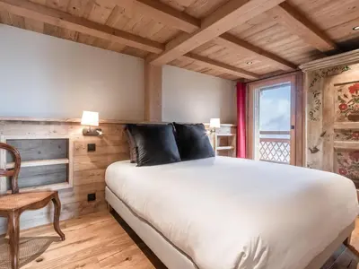 a kitchen with wooden cabinets and stainless steel appliances at Chalet rénové pour 10 pers., St-Gervais, balcon, parking - FR-1-663-54 in Saint-Gervais-les-Bains