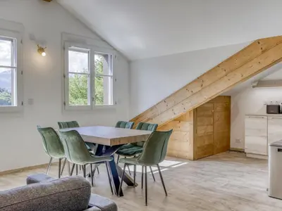 a dining room with a wooden table and green chairs at Duplex 4 pièces, 3 chambres, 6 personnes, proche centre, parking, wifi - FR-1-663-52 in Saint-Gervais-les-Bains