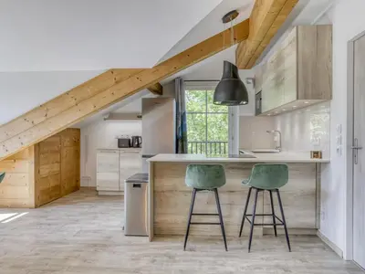 two beds in a room with wooden walls and a window at Duplex 4 pièces, 3 chambres, 6 personnes, proche centre, parking, wifi - FR-1-663-52 in Saint-Gervais-les-Bains