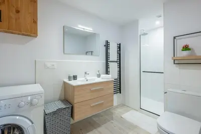 a bathroom with a sink and a washing machine at Apartment at the foot of the slopes with view in Les Houches