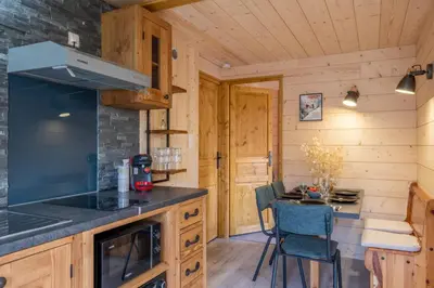 a kitchen with a stove and a counter top at Apartment at the foot of the slopes with view in Les Houches