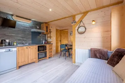 a kitchen and living room with a bed in a room at Apartment at the foot of the slopes with view in Les Houches
