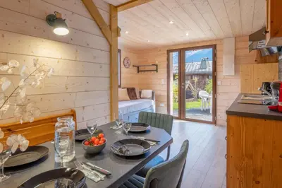 a dining room with a table in a log cabin at Apartment at the foot of the slopes with view in Les Houches