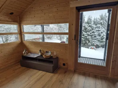 a hallway of a wooden house with a door at Chalet refait à neuf avec parking privé - 4 pers. - FR-1-836-38 in Arâches-la-Frasse