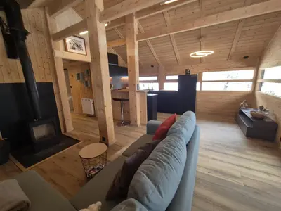 a living room with a couch and a table at Chalet refait à neuf avec parking privé - 4 pers. - FR-1-836-38 in Arâches-la-Frasse