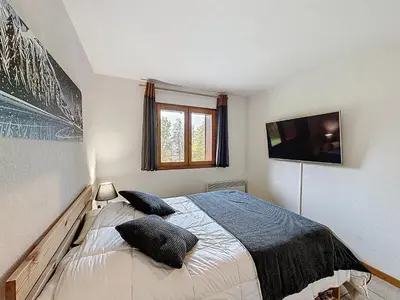 a bedroom with a bed with two pillows on it at Charmant 2 Pièces proche piste à Combloux - FR-1-560-169 in Combloux