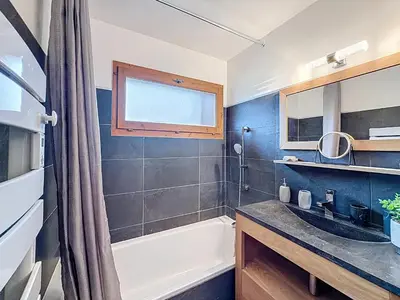 a bathroom with a bath tub and a sink at Charmant 2 Pièces proche piste à Combloux - FR-1-560-169 in Combloux