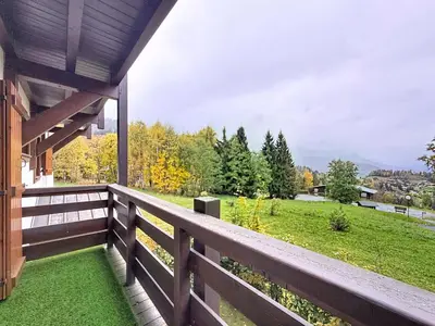 a porch with a fence and a view of a field at Charmant 2 Pièces proche piste à Combloux - FR-1-560-169 in Combloux