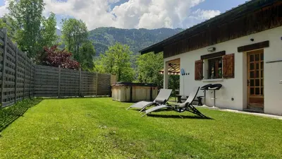 a yard with two chairs and a house at Chalet Mugnier in Samoëns
