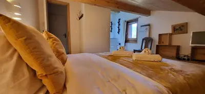 a bedroom with a large bed with two pillows on it at Chalet Mugnier in Samoëns