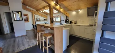 a kitchen with a island in a tiny house at Chalet Mugnier in Samoëns