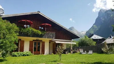 a house with two red umbrellas on top of it at Chalet Mugnier in Samoëns