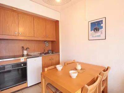 a kitchen with a wooden table and a kitchen counter at Studio cosy 4 pers, 300m des pistes, Flaine - FR-1-687-97 in Arâches-la-Frasse