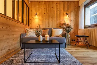 a living room with a couch and a table at Argy - Apart Moderne - Vue MtBlanc - 5mn Pistes - Parking in Chamonix-Mont-Blanc