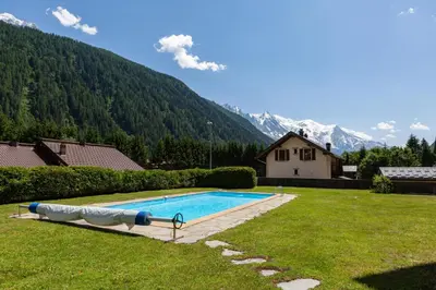 a swimming pool in a yard with a house at Argy - Apart Moderne - Vue MtBlanc - 5mn Pistes - Parking in Chamonix-Mont-Blanc