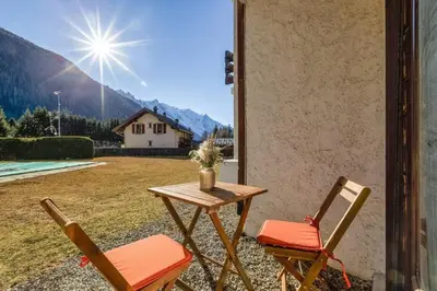 a table and two chairs on a patio at Argy - Apart Moderne - Vue MtBlanc - 5mn Pistes - Parking in Chamonix-Mont-Blanc