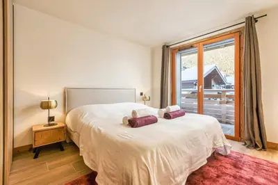 a bedroom with a bed with two pillows on it at Wim in Les Houches