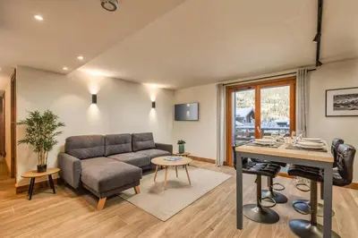 a living room with a couch and a table at Wim in Les Houches