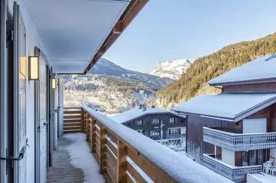a balcony with a view of snow covered mountains at Wim in Les Houches