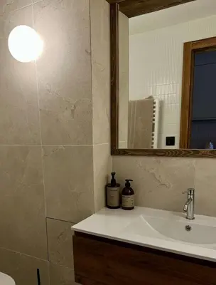 a bathroom with a sink and a mirror at Cocon de charme à Megève, confort et vue in Megève