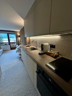 a kitchen with a sink and a counter top at Cocon de charme à Megève, confort et vue in Megève