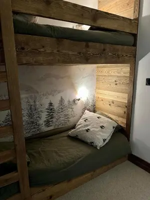 a bunk bed in a room with a bed at Cocon de charme à Megève, confort et vue in Megève