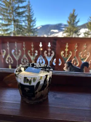 a black and white cup on a table with a window at Cocon de charme à Megève, confort et vue in Megève