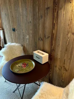 a table with a plate and a box on it at Cocon de charme à Megève, confort et vue in Megève