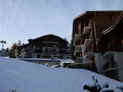 a building with snow on the side of it at 2 bedroom apartment, in Saint-Gervais-les-Bains