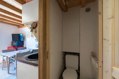 a small kitchen with a toilet in a room at 2 bedroom apartment, in Saint-Gervais-les-Bains