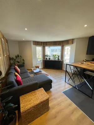 a living room with a couch and a table at BlackWood Lodge in Saint-Gervais-les-Bains