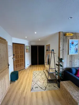 a living room with a couch and a ladder at BlackWood Lodge in Saint-Gervais-les-Bains