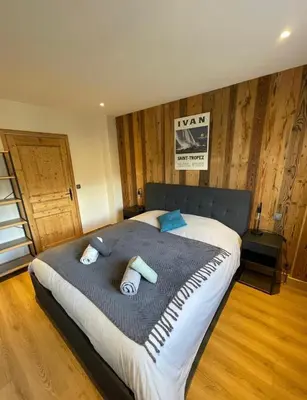 a bedroom with a large bed with two pillows on it at BlackWood Lodge in Saint-Gervais-les-Bains