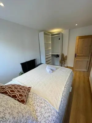 a bedroom with a large bed and a closet at BlackWood Lodge in Saint-Gervais-les-Bains