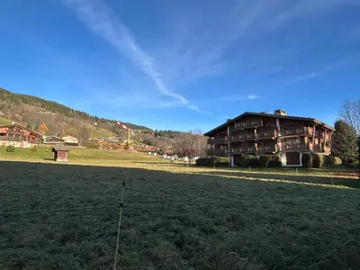 a large house in the middle of a field at Sunny 2 Bedrooms Apartment for 4 in Megève Jaillet, right on the Ski Slopes in Megève