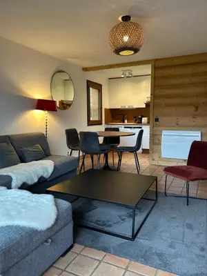 a living room with a couch and a table at Sunny 2 Bedrooms Apartment for 4 in Megève Jaillet, right on the Ski Slopes in Megève