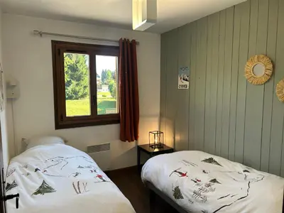 a bedroom with two beds and a window at Sunny 2 Bedrooms Apartment for 4 in Megève Jaillet, right on the Ski Slopes in Megève