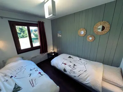 a bedroom with two beds and a window and mirrors at Sunny 2 Bedrooms Apartment for 4 in Megève Jaillet, right on the Ski Slopes in Megève