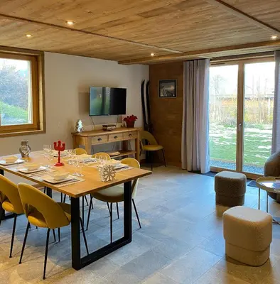 a large dining room with a table and chairs at Chalet Maloya, confortable appartement proche remontées et village, prestations premium in Saint-Gervais-les-Bains