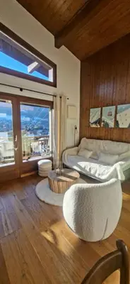 a bedroom with a bed and a large window at Joly Story in Megève