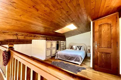 a bedroom with a bed and a wooden ceiling at Joly Story in Megève