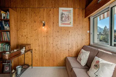 a living room with a couch and a window at Apartment Mika , Alpes Travel, Slope side location, Central Chamonix, Sleeps 4 6 in Chamonix-Mont-Blanc