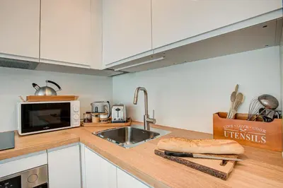 a kitchen counter with a sink and a microwave at Apartment Mika , Alpes Travel, Slope side location, Central Chamonix, Sleeps 4 6 in Chamonix-Mont-Blanc