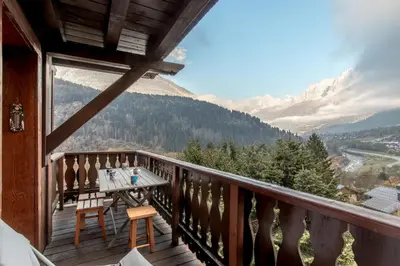 a balcony with a table and a view of mountains at Grand Balcon 7 in Les Houches