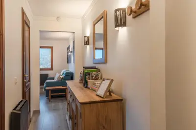 a hallway with a wooden desk in a house at Grand Balcon 7 in Les Houches