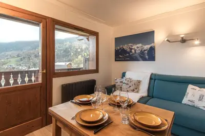 a dining room with a table and a couch at Grand Balcon 7 in Les Houches