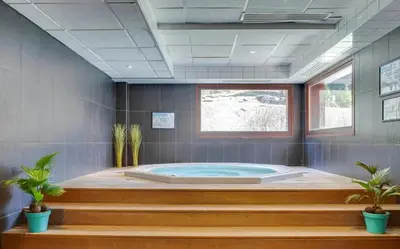 a jacuzzi tub in a room with plants at Appartement LE BUET skis aux pieds, piscine & Spa in Vallorcine