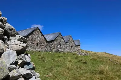 an old stone building on top of a hill at Appartement LE BUET skis aux pieds, piscine & Spa in Vallorcine