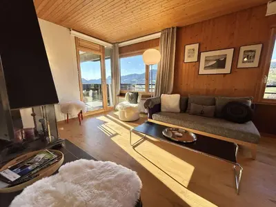 a living room with a couch and a large window at Appartement Megève 3 pièces, 4-6 personnes, parking - FR-1-597-195 in Megève